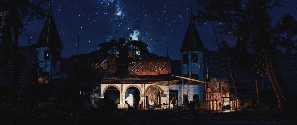A lit building with two towers under a starry night sky